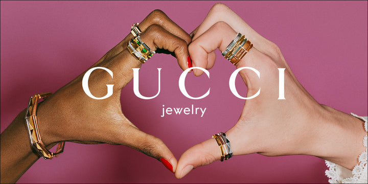 Gucci jewelry two hands making a heart with gucci rings on fingers 